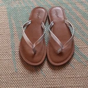 Tan and silver flip flops